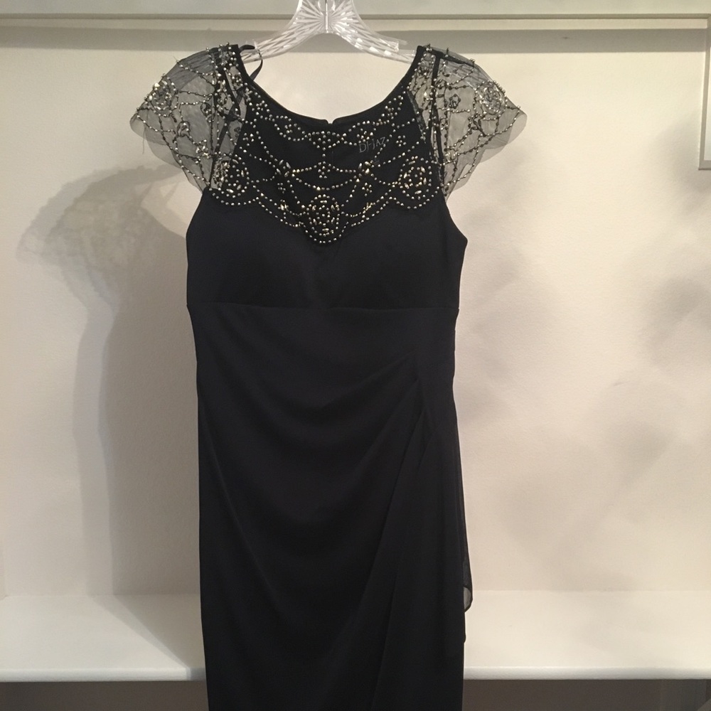 Formal navy dress with embellished sleeves.